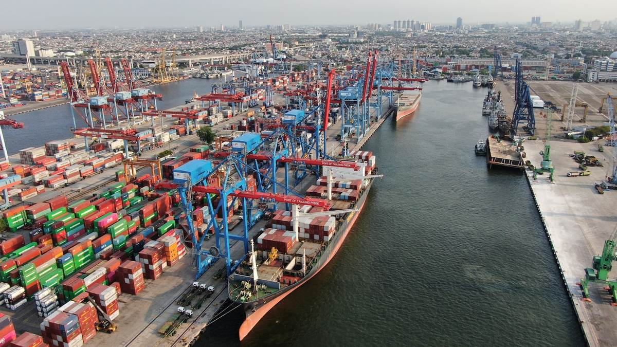 Aerial view of a container terminal with gantry cranes and stacked shipping containers